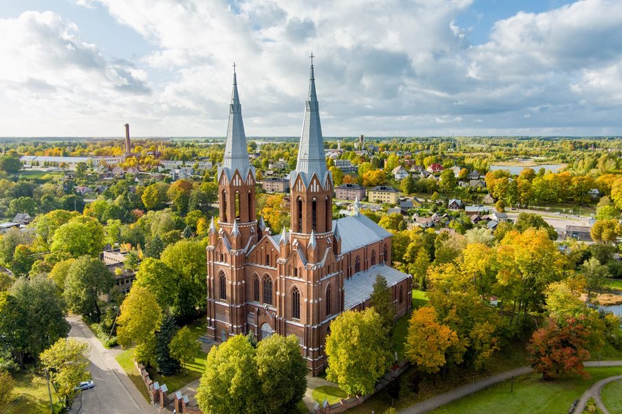 The red-brick church of St. Matthew in Anykščiai among autumn trees