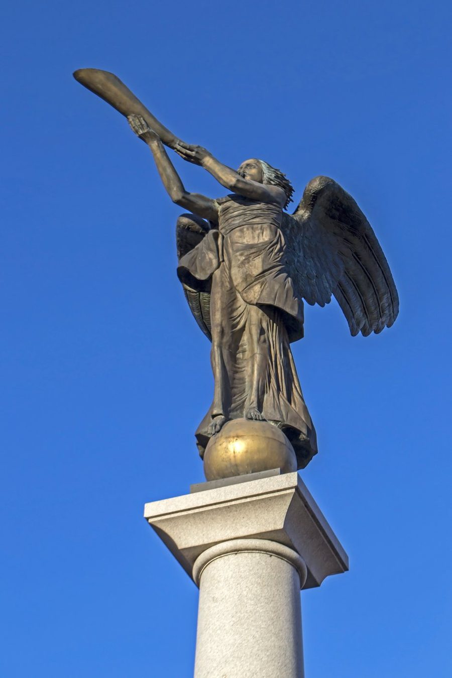 The bronze Angel of Užupis blowing a trumpet